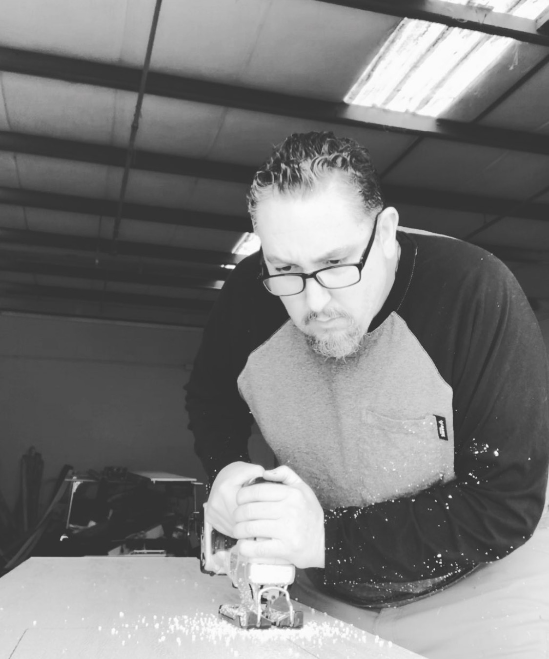 Eric using a jigsaw during a carpentry project